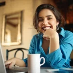 Mulher sorrindo trabalhando como funciona a perícia do INSS